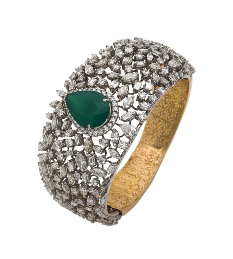 Cuff crafted in 18K gold with fine cut diamonds and emeralds 